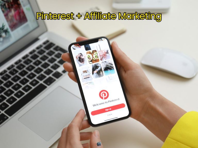 Person holding a smartphone with the Pinterest login screen, positioned above a laptop—illustrating the concept of using Pinterest for affiliate marketing.