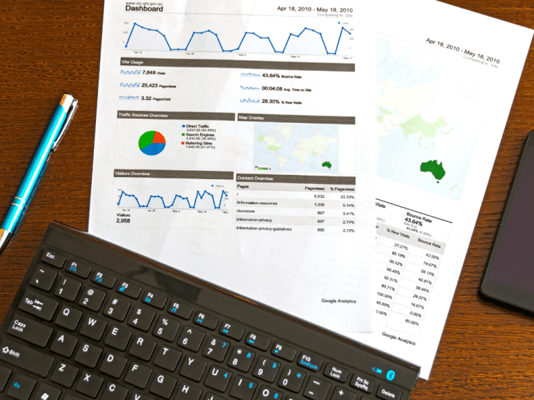 A paper with analytics or stats and a black keyboard.