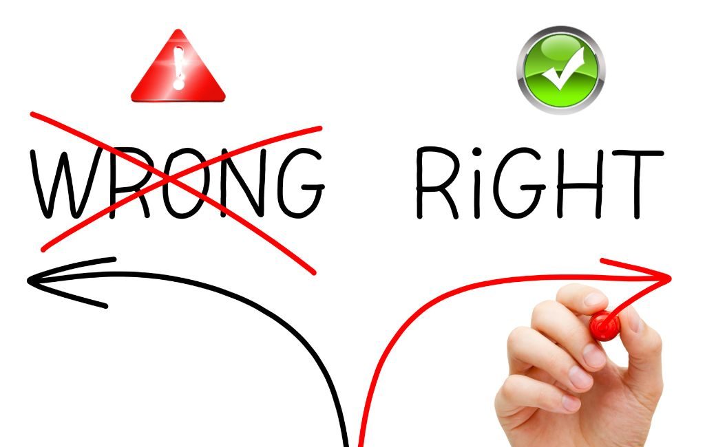 Hand drawing two arrows: one pointing left toward "Wrong" with a red cross and warning symbol, and another pointing right toward "Right" with a green check mark, symbolizing correct decision-making.